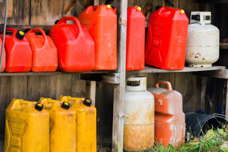 Gas cans and propane tanks on shelves