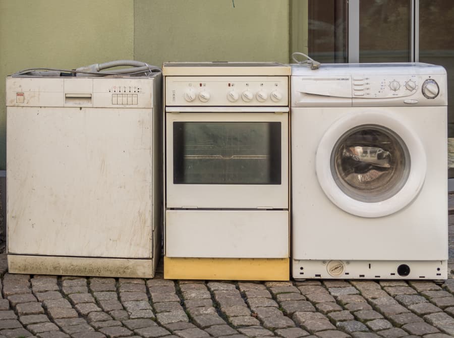 Old dishwasher with oven and drying sitting outside