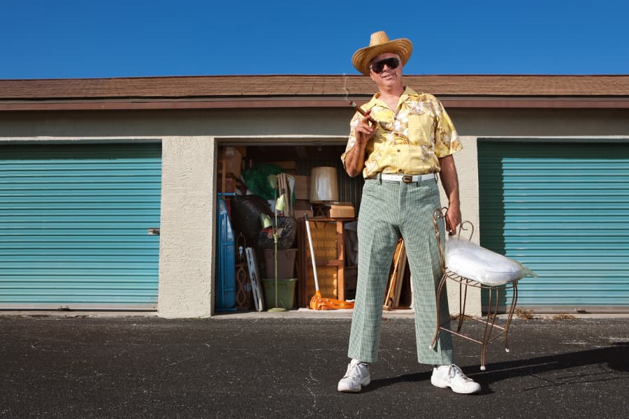 an older man standing in front of storage units