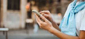 Customer using phone to connect to Quikstor app to open gate of storage unit facility 