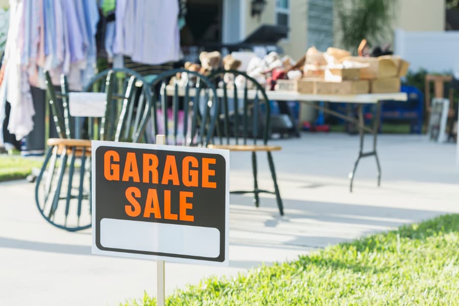 A Sign At A Garage Sale On Front Yard