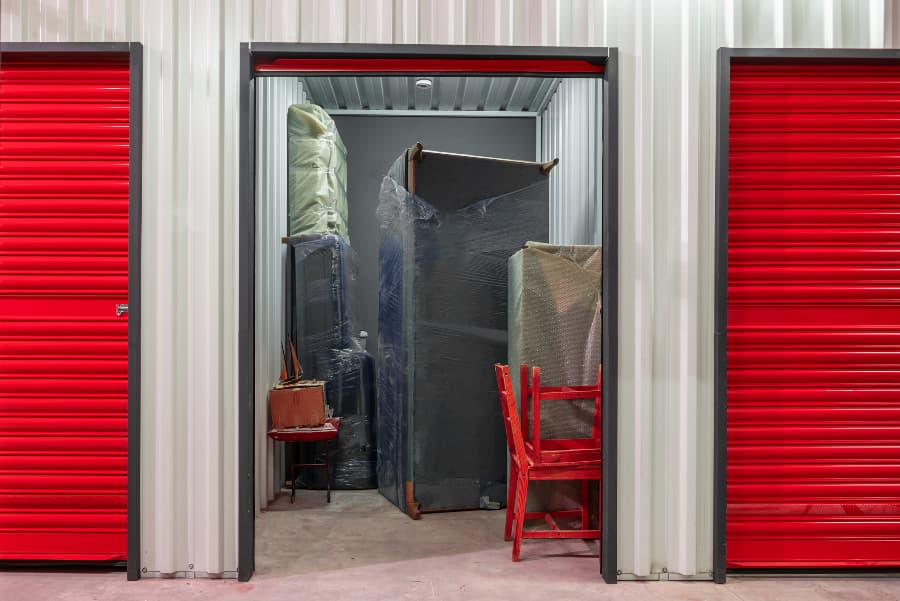 Storage unit with open door filled with furniture