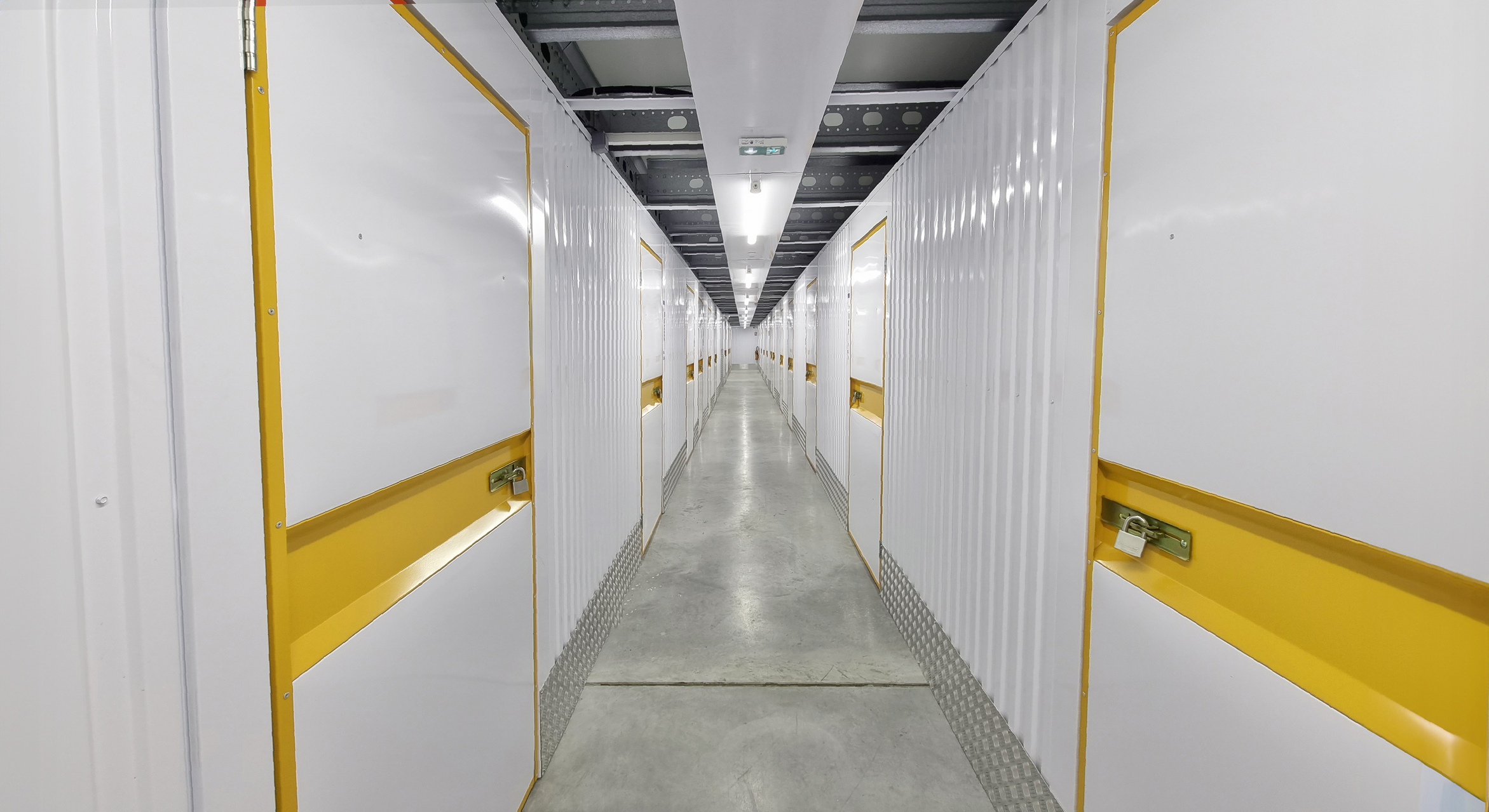 Hallway of storage warehouse with doors to units showing