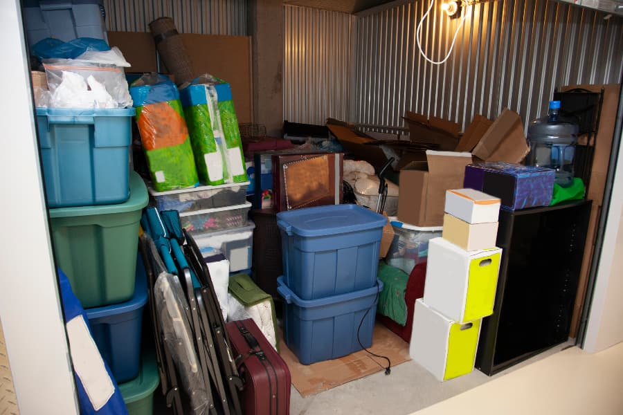 Interior of cluttered storage unit with shelving